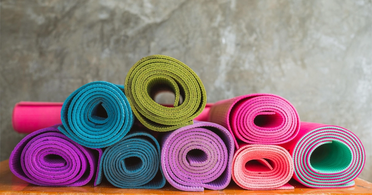 Colorful stack showing variety among the best yoga mat brands.