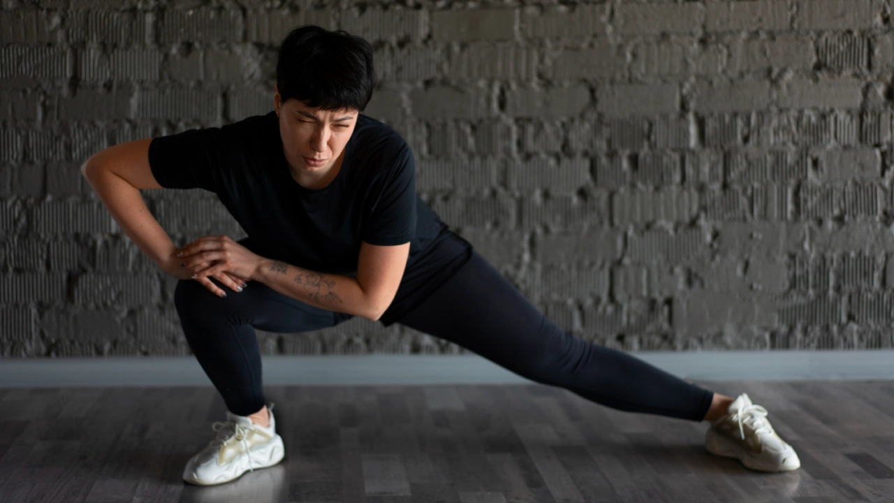 Athlete performing dynamic warm-up exercises as part of their 7-day gym workout plan preparation.