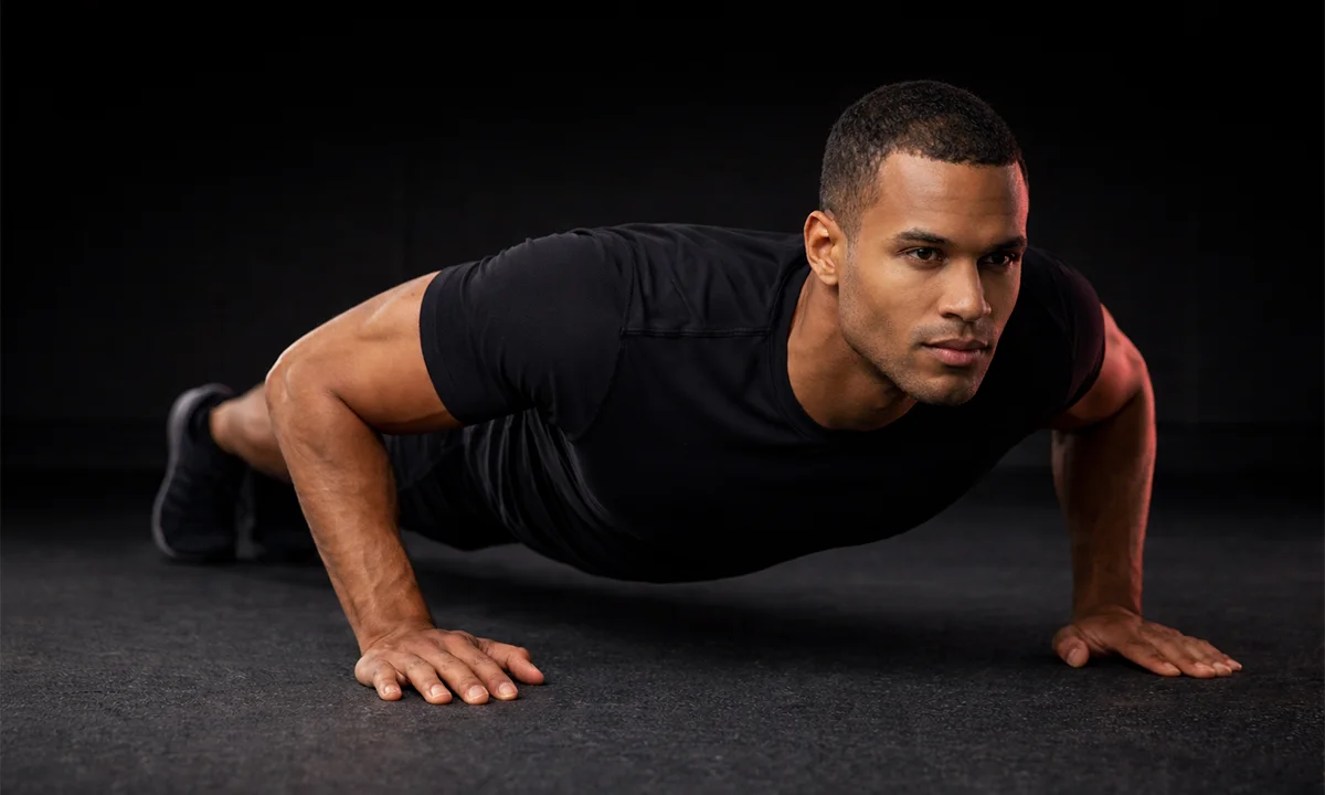 LIFE FIT: Man demonstrating proper push-up form for chest workout and strength building.